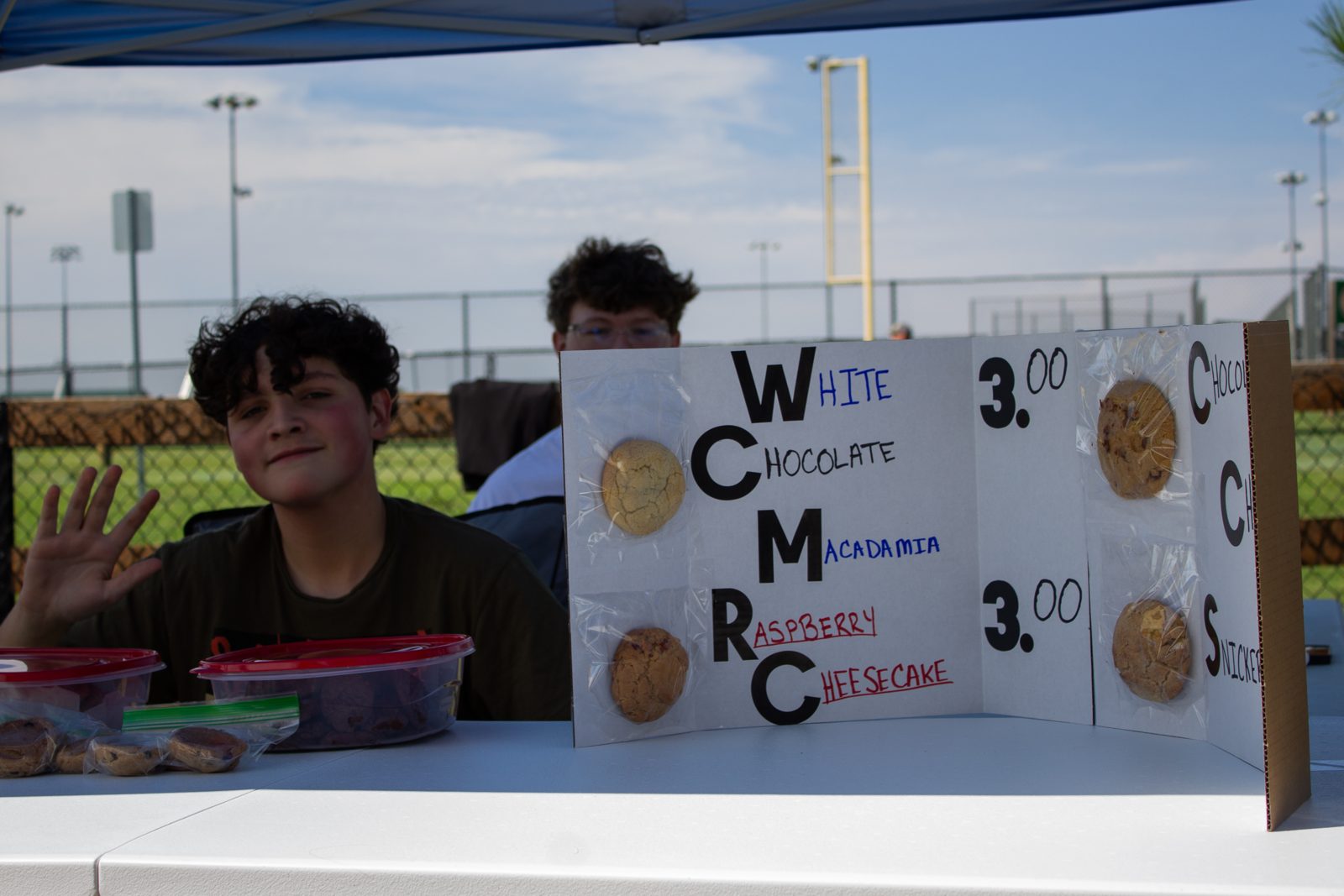 A handmade bake sale menu with cookie flavors and prices