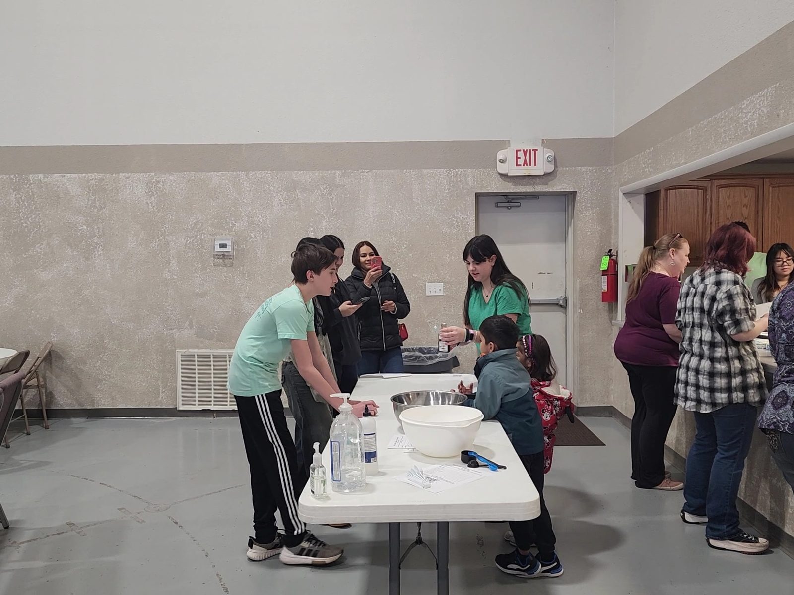 Community members gathered around a workshop table
