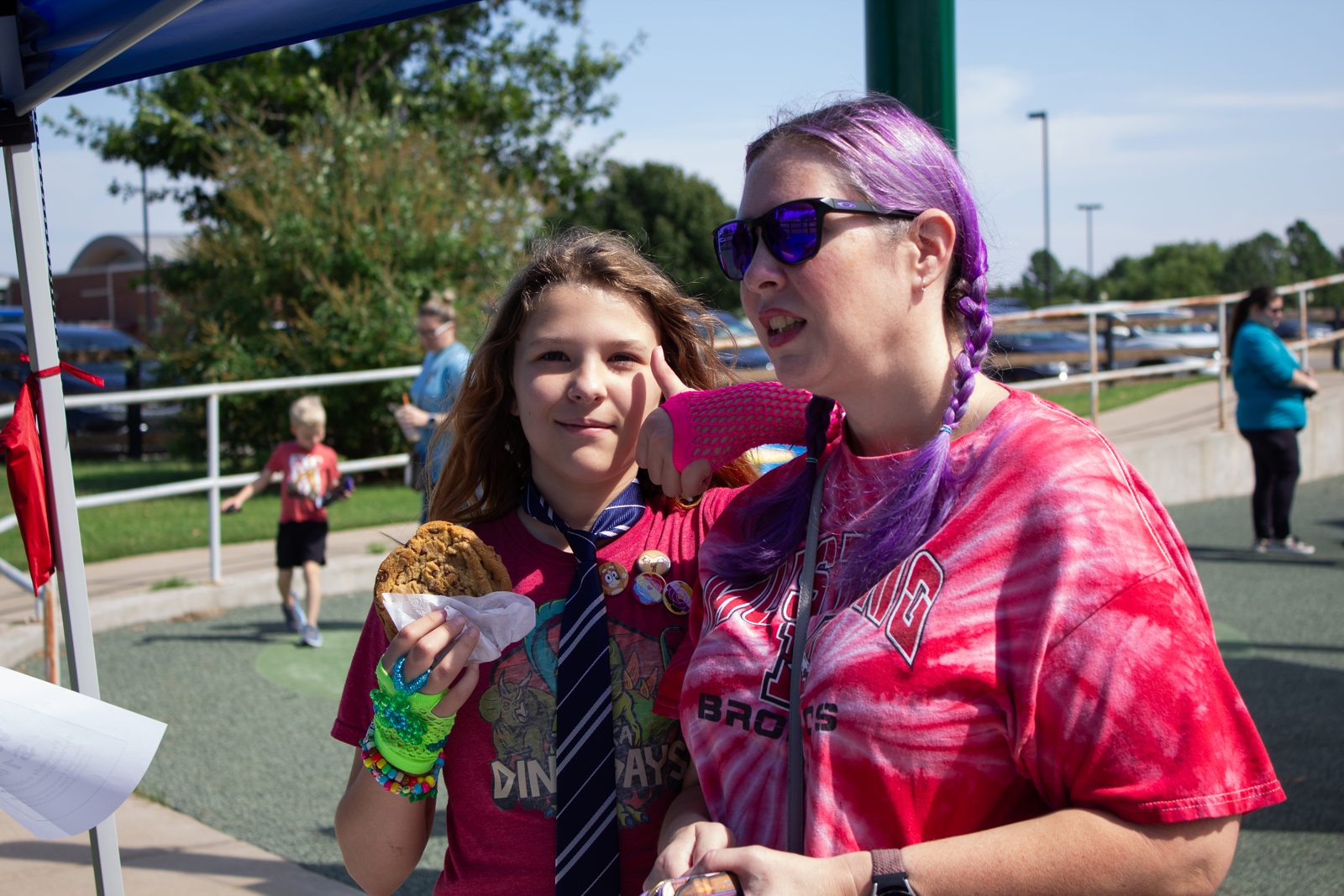 A community member holding a cookie at a BIF event
