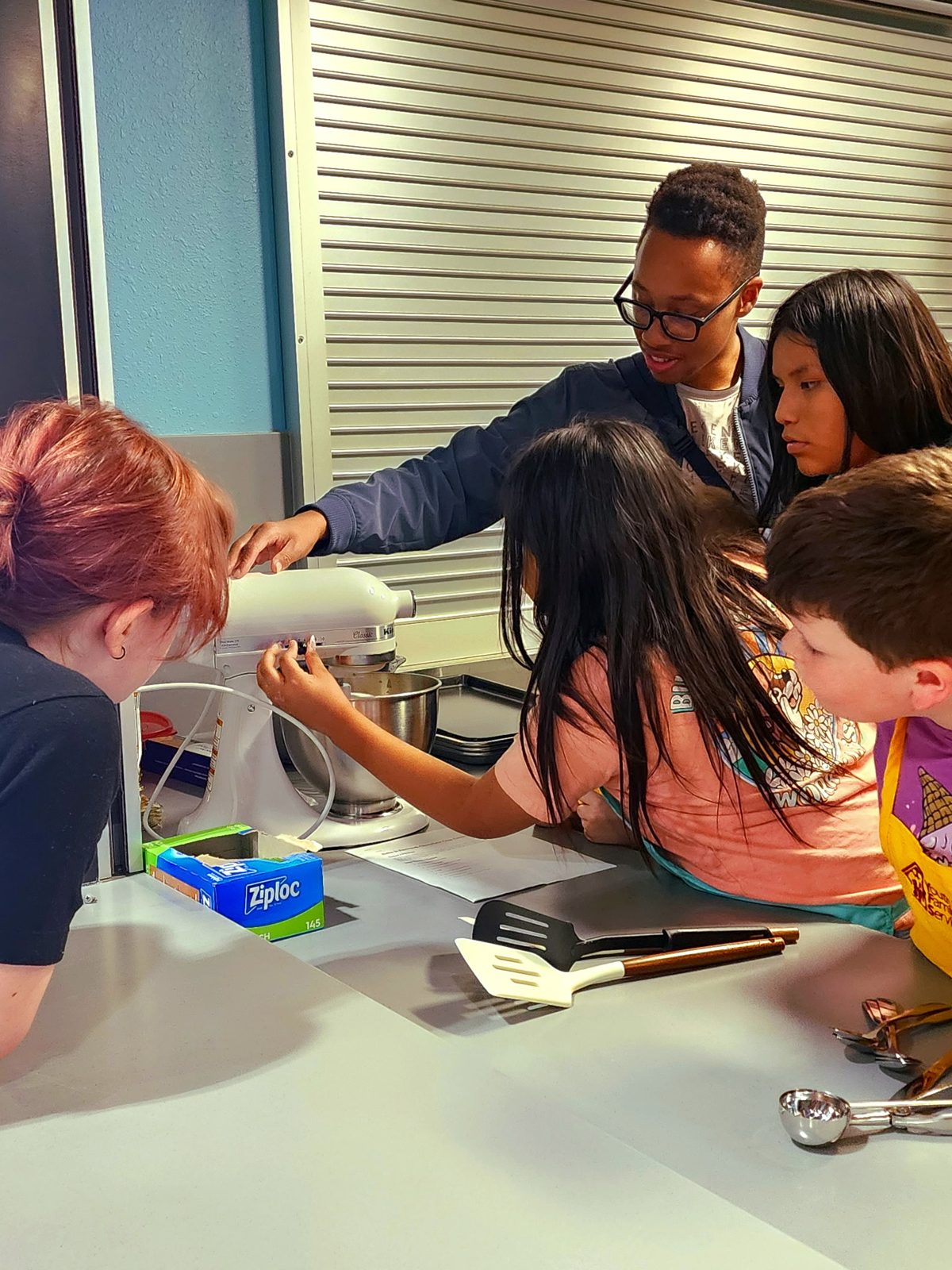 Kids learning to use a stand mixer at a BIF workshop