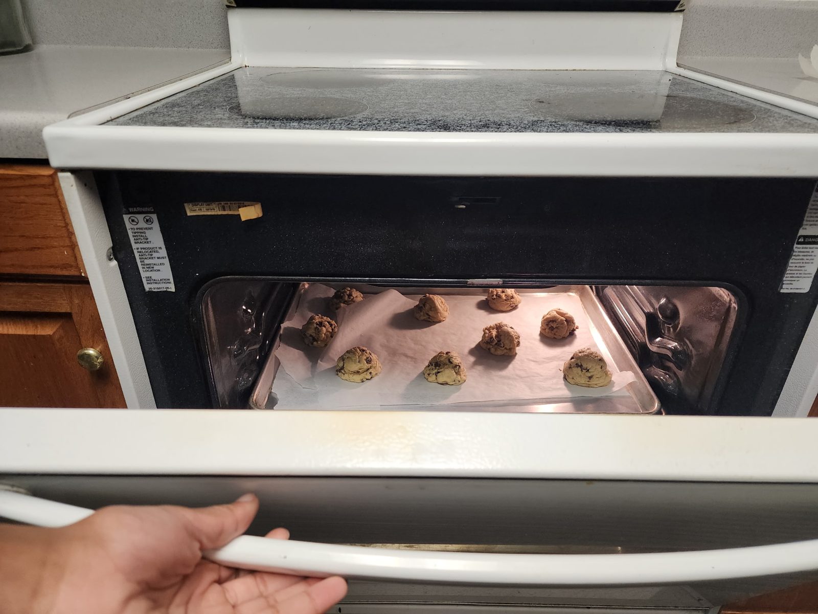 A tray of cookie dough going into the oven